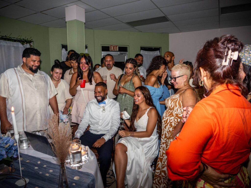 Wedding Party Reacting to Video on Laptop